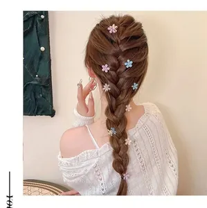 Mini camellia hair clips with pearls shown in an elegant hairstyle on model back view