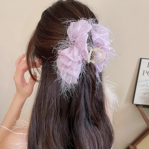 Gros plan sur une pince à cheveux en tulle violet avec détails de franges délicates