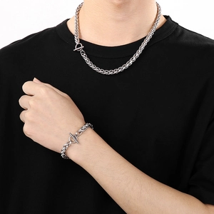 Minimalist silver stainless steel OT toggle necklace and bracelet set on a black T-shirt