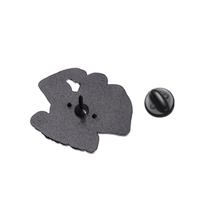 Detail view of the black enamel badge back with sandblast texture and rubber clutch
