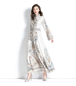 Macro detail of paisley floral print and silk texture on long bell sleeve dress