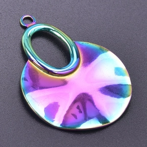 Macro shot of circular rainbow plated stainless steel pendant with oval link detail