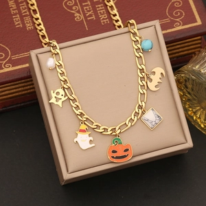 Gold Halloween charm bracelet with pumpkin ghost and bat pendants on a jewelry box