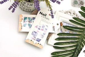 Macro detail of waterproof toe nail wraps with purple marble texture and shell pattern