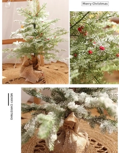 Close-up of mini artificial Christmas tree with red berries and burlap base decor