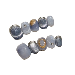 Handmade press-on nails in blue marble marble with silver cat eye and gold metallic trim