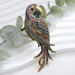 Detailed close-up of a vibrant parrot brooch featuring colorful rhinestones and gold beak