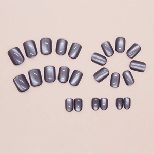 Detail of short square press-on nails with 24 pieces in grey cat-eye shimmering finish