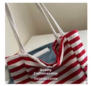 Detailed close-up of red and white striped canvas tote bag with thick rope handles