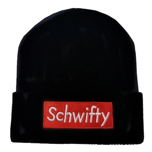 Detailed view of black knitted beanie with red Schwifty embroidery patch on the cuff