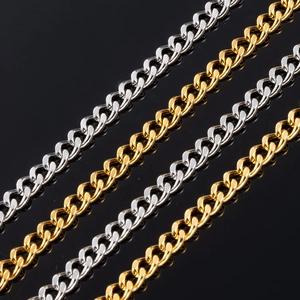 Polished silver and gold Cuban link chains displayed on a reflective black background