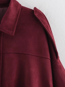 Detailed view of the burgundy faux suede jacket collar and shoulder epaulettes