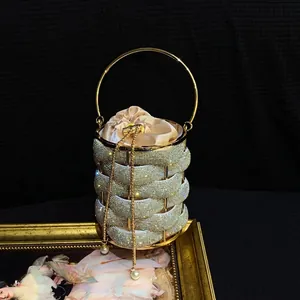 Detail of metal woven evening bag with sparkling rhinestones and champagne satin liner