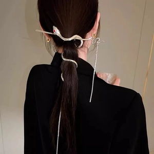 Silver snake hair pin with red gem eyes and long tassel chains on model hair