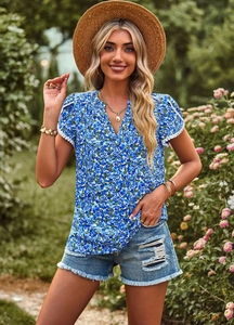 Detail view of women's V-neck blue floral short sleeve top with lightweight fabric texture