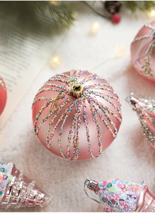 Macro detail of pink matte Christmas ball and star ornament with glitter on white fur