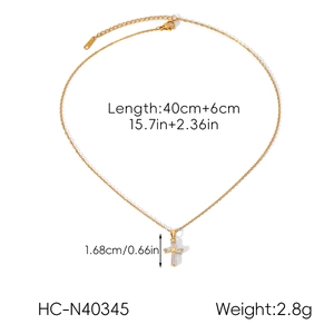 Detail view of gold cross necklace with crystal pendant including length and size parameters