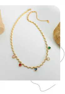 Detailed shot of golden rope chain necklace with colorful heart-shaped zircon pendants