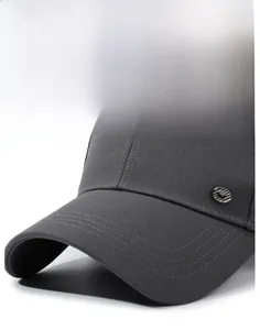 Close-up of dark grey baseball cap with twill fabric texture and reinforced stitched brim