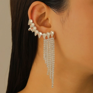 Close-up of sparkling zircon star ear cuff with long shimmering silver tassels