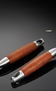 Detail of ergonomic rosewood handle on a stainless steel skimmer with a hanging hole