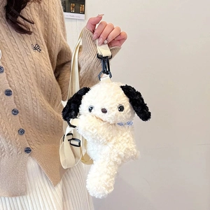 Close-up of cute plush puppy backpack with adjustable strap being held by a model