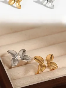 Detail of adjustable open rings in gold and silver leaf wing design on velvet