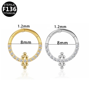 Detailed comparison of 1.2mm x 8mm sterile F136 titanium clicker rings in gold and silver