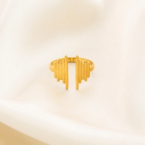 Detail of 18K gold-plated irregular ring with hammered texture on soft cream fabric
