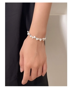 Close-up of baroque irregular pearl bracelet on wrist with elegant 925 silver beads