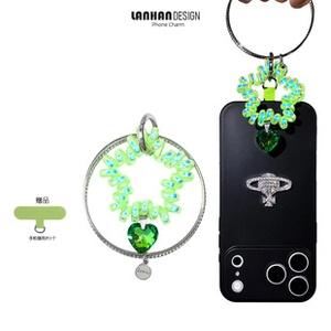 Neon green spiral star phone strap with a large dark green faceted heart gemstone detail