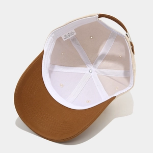 Detailed inner view of 100% cotton baseball cap showing stitching and metal buckle