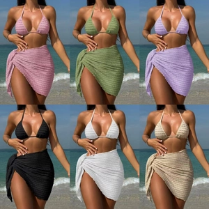 Detailed view of 3-piece bikini sets with textured fabric and matching beach sarongs
