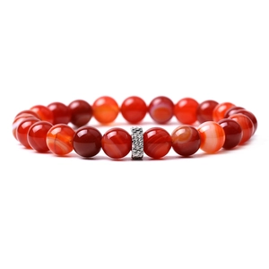 Macro shot of red agate beaded bracelet with polished texture and silver metal spacer bead