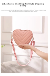 Detail of pink heart-shaped crossbody bag featuring V-shaped quilted stitching and wide strap
