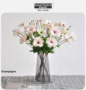 Detail of 3-head white and purple artificial poppy silk flowers in a grey glass vase