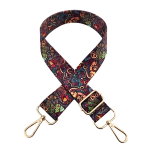Detail showing adjustable colorful polyester strap with gold hooks and graffiti pattern