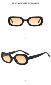 Detail view of vintage oval sunglasses with black frames and translucent orange lenses