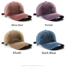 Detail view of washed denim baseball caps with 3D letter W embroidery in four vintage colors