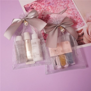 Grey organza drawstring gift bag with pearl charm and ribbon bow for cosmetics