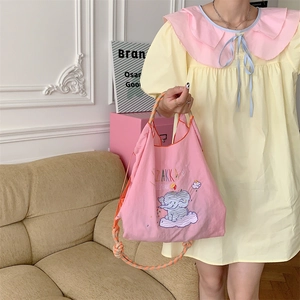 Detail of pink embroidered elephant tote bag featuring Zakka style drawstring and rope handles