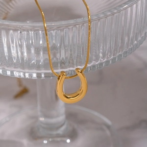 Polished 18K gold-plated U-shaped horseshoe pendant necklace with a fine snake chain
