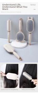 Detail view of cream hair brush set including paddle and roller combs with rose gold accents