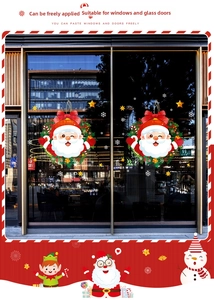 Detail of cartoon Santa Claus window decals with red bows and snowflake stickers