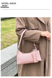 Pink woven texture underarm bag with matching coin purse shown on a brown wool coat