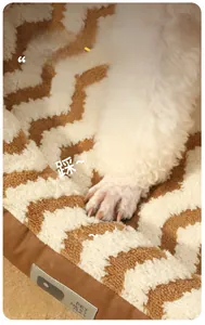 Close-up of soft brown wave pattern pet mat with leather piping and thick plush texture