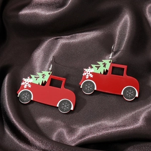 Detailed view of red retro truck acrylic earrings with Christmas tree on silk background