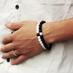 Detail of 8mm tiger eye beads bracelet and minimalist diamond ring on hand