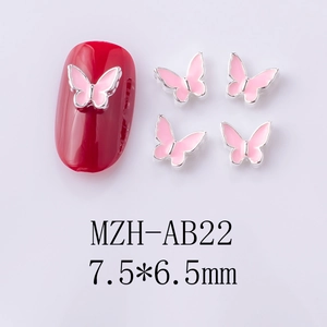 Detail of pink enamel butterfly nail charm sized 7.5x6.5mm with silver alloy edges