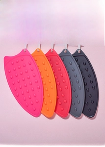 Silicone iron rest pads in multiple colors with non-slip bumps and hanging hole design